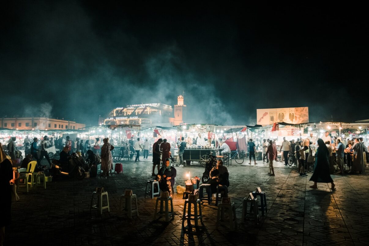 people standing on a beach during night time